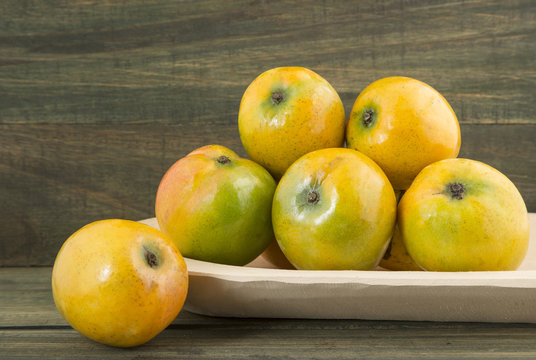 Mango tropical fruit on a wooden background