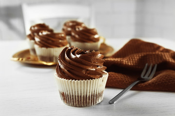Chocolate cupcakes with fork on light table, close up