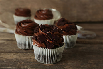 Chocolate cupcakes on wooden background