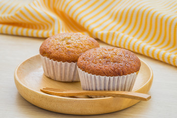 Banana cupcake on wooden plate