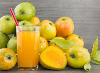 Mango juice and fresh mango on a dark wood background. tinting. selective focus