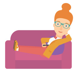 Woman sitting on the couch with remote control.