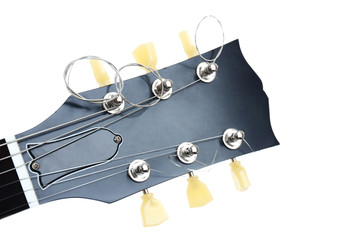 Head stock of electric guitar with tuning pegs, isolated on white