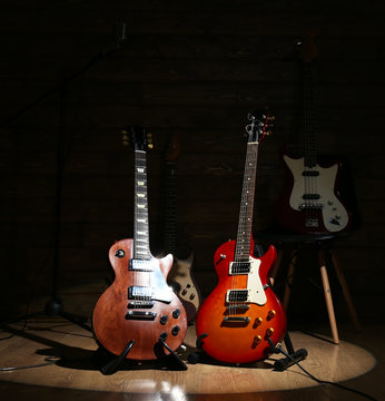 Electric guitars on lighted wooden background