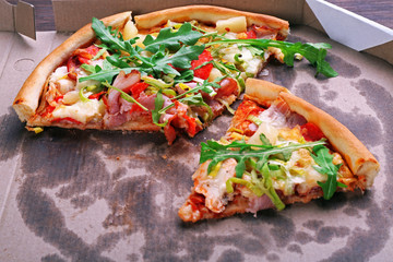 Sliced fresh pizza on cardboard background