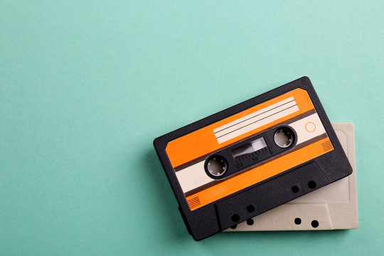 Old audio cassettes on turquoise  background
