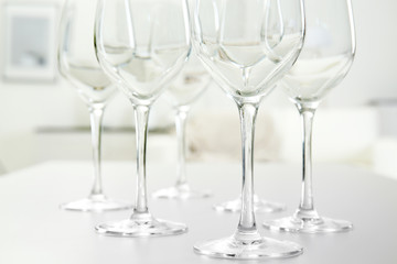 Wineglasses on blurred interior background