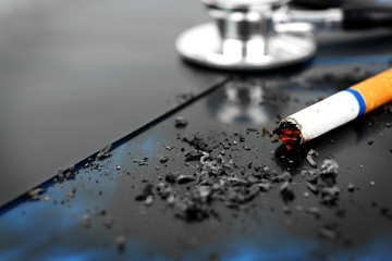 Cigarette and stethoscope on x-ray lung, close up