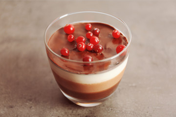 Delicious dessert with rowan in glass