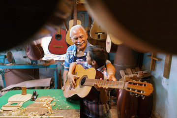 Boy Learns Play Guitar With Senior Man Grandpa