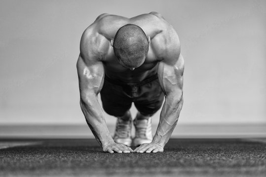 Bodybuilder Exercising Push Ups On Floor