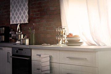 Modern kitchen interior with white furniture and electric stove