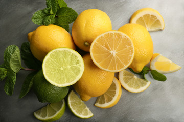 Sliced fresh lemon with green leaves on tray closeup