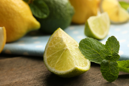 Slices of fresh lemon and lime on blue napkin closeup