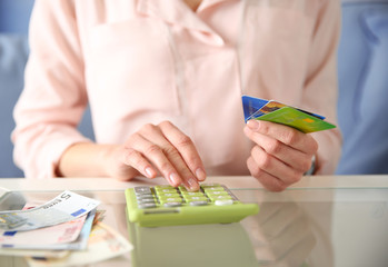 Female calculate with credit card and euro money, closeup