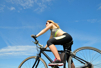 Fototapeta na wymiar Girl on bike in sunny day.