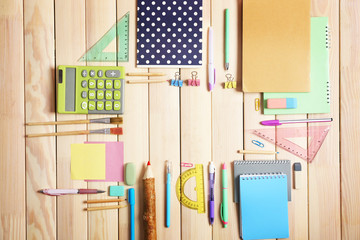 Flat lay of stationery on wooden background, copy space