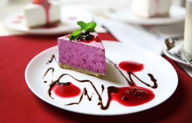 Tasty cheesecake on table in cafe or restaurant