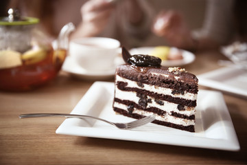 Tasty chocolate cake on table in cafe or restaurant