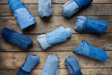 Collection jeans rolled on a wooden background