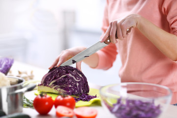Woman chopping vegetables in kitchen