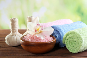 Spa treatment with sea salt on wooden table