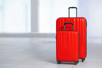 Red polycarbonate suitcases on the floor