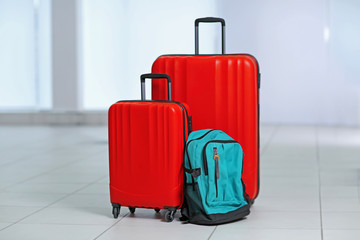 Different suitcases on tile floor