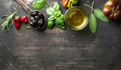 Food background with vegetables, herbs and condiment. Greek black olives, fresh basil, sage,...