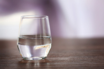 Glass of fresh water on wooden table