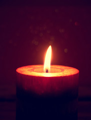 Red burning candles on rustic wooden table. 
