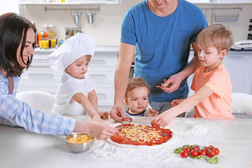 Young family making a pizza, close up
