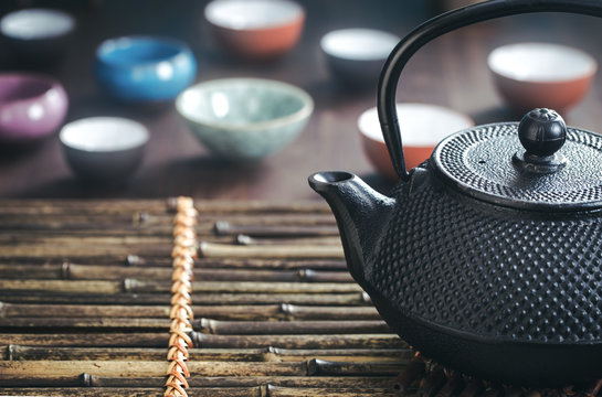 Traditional oriental teapot on bamboo placemat