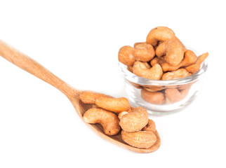 Glass bowl full with cashew nuts. Isolated