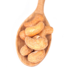Glass bowl full with cashew nuts. Isolated on a