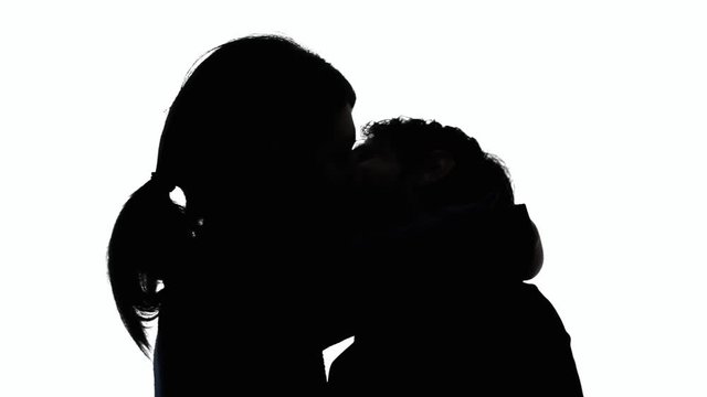 A man and a woman in love, kissing and touching each other passionately. Silhouette shot. Lovers, Valentine, attraction.