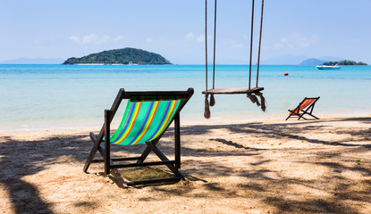 sun beach chairs on shore near sea.