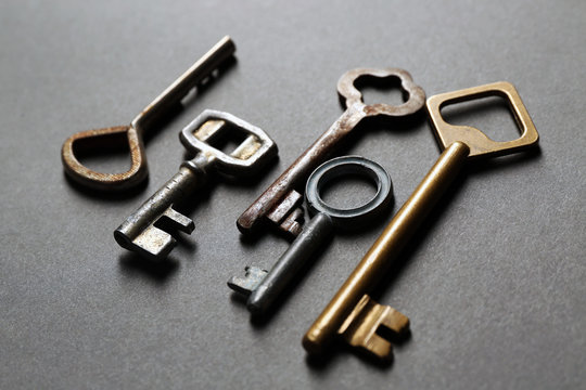Group of old keys on grey textured background