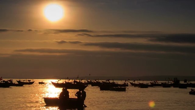 Fishing Boat Silhouette Rows in Sea Bay at Sunset in Vietnam
