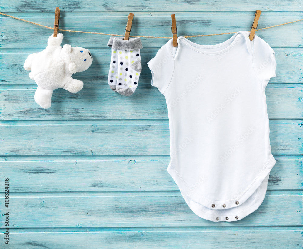 Wall mural Baby boy clothes and white bear toy on a clothesline - Wall murals