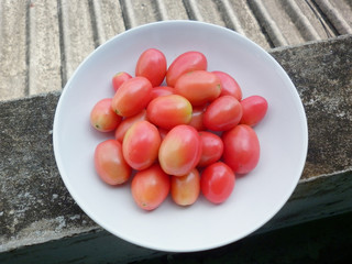 fresh tometo on white dish grunge background 4