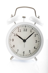 White alarm clock shows 7 after 10