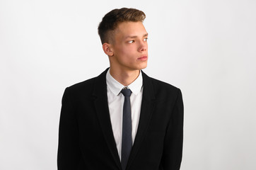 portrait of young stylish businessman on gray background
