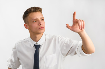 portrait of young stylish businessman on gray background