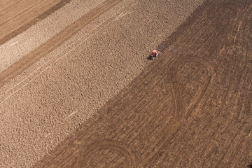 Fototapeta na wymiar aerial view of over the tractor on harvest field