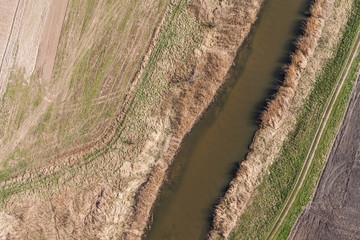 aerial view of  over the   river and harvest fields