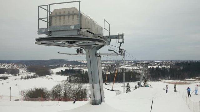 perspective detail ski lift mechanism.Skiers going uphill on ski lift.
