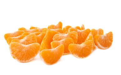 Surface covered with slice sections of tangerine isolated over the white background