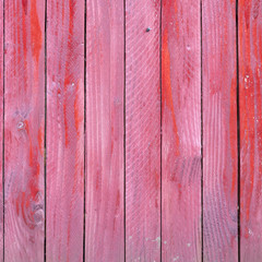 vertical planks of red painted worn planks on fence or door