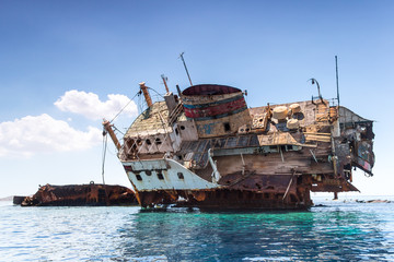 The broken rusty ship at red sea